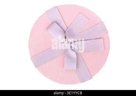 Elegant round pink gift box with ribbon isolated on white background. Minimal festive composition suitable for celebration and gift concepts. Stock Photo