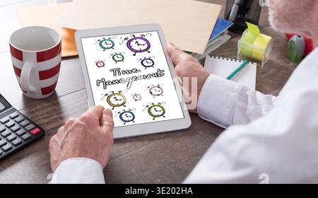 Time management concept shown on a tablet held by a man Stock Photo