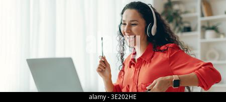 Woman Engaged in Virtual Learning With Excitement While Using a Laptop Stock Photo
