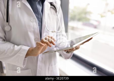 Close-up of female doctor using tablet device Stock Photo