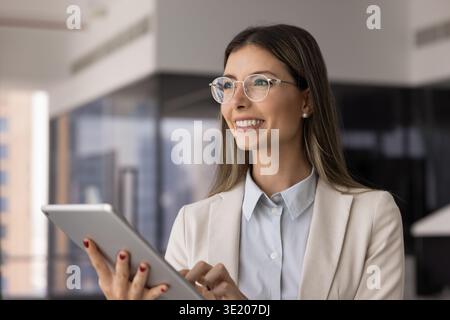 Closeup beautiful Hispanic professional woman working on tablet device Stock Photo