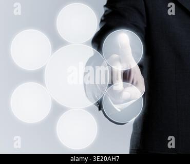 Businessman touching infogram graphics on virtual touchscreen with copy space Stock Photo