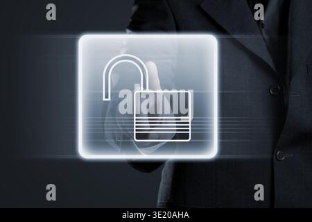 Businessman pressing lock button on futuristic touchscreen Stock Photo