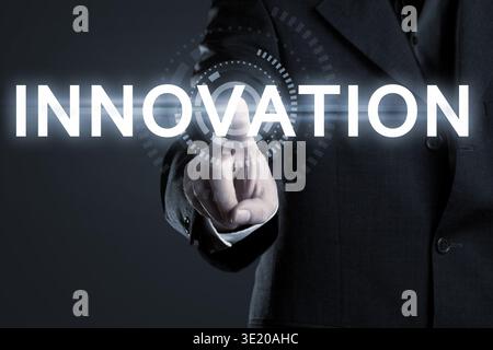 Business man touching the word Innovation on virtual screen Stock Photo