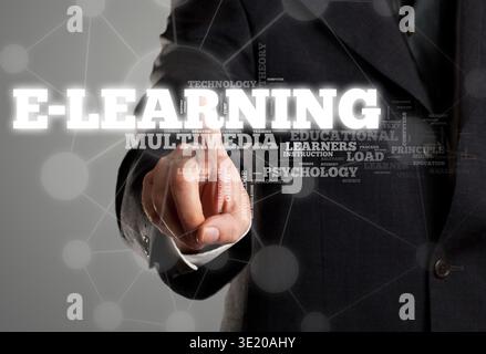 Businessman touching e-learning in wordcloud on transparent surface display Stock Photo