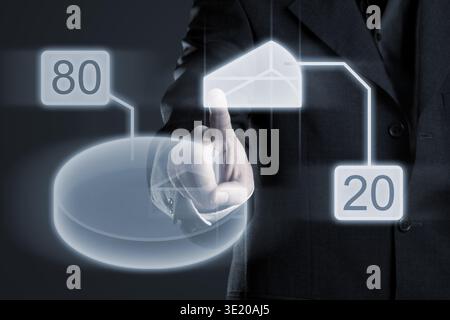 Businessman navigating eighty/ twenty percent data in pie chart on futuristic touchscreen display Stock Photo