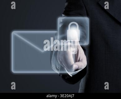 Businessman touching virtual futuristic display with icon for secure email communication Stock Photo