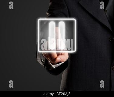 Businessman pressing pause button on virtual screen Stock Photo
