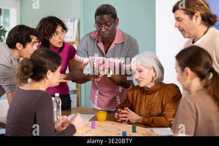 Group of people playing board game Stock Photo