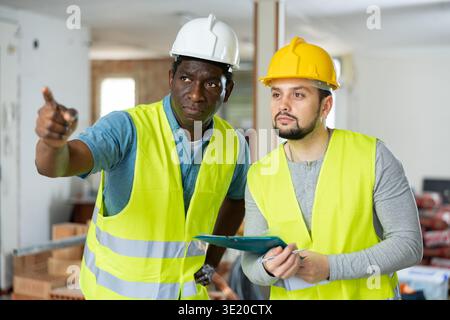 Two engineers discussing work in apartment Stock Photo
