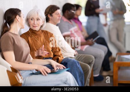 People are sitting in line and waiting for an interview Stock Photo