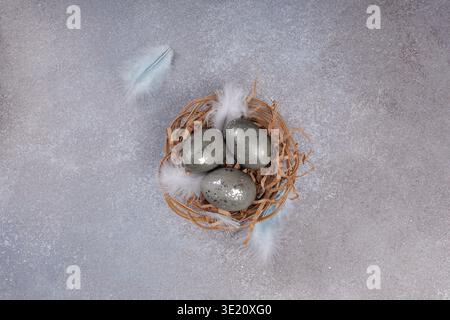 Easter eggs with silver texture in rustic nest top view Stock Photo