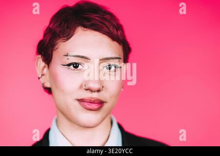 Young woman confidently posing with unique style Stock Photo