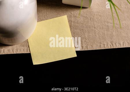 Empty yellow sticky note on desk with copy space, minimal reminder and mockup concept Stock Photo
