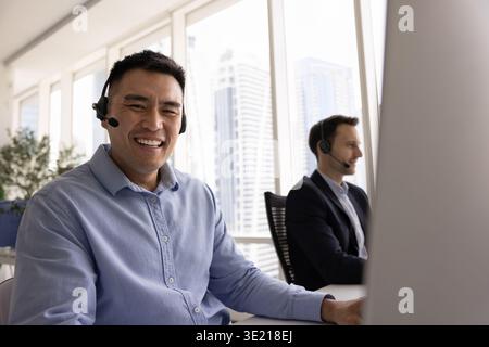 Young man customer service worker looking at camera with smile Stock Photo
