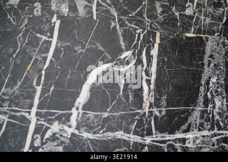 Dark stone surface with white veins and patterns Stock Photo