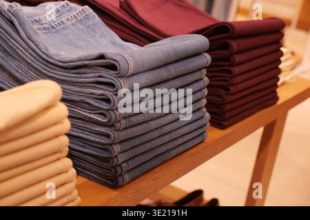 Jeans stacked neatly on display at a retail store Stock Photo