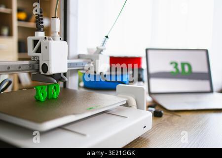 3D Printer Creating Green Letters Stock Photo