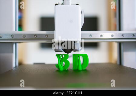 3D Printer Creating Green Letters Stock Photo