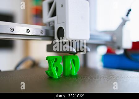 3D Printer Creating Green Letters Stock Photo