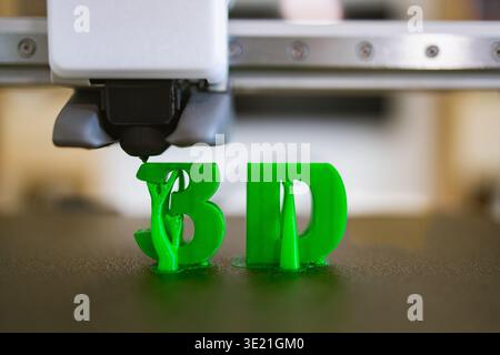 3D Printer Creating Green Letters Stock Photo