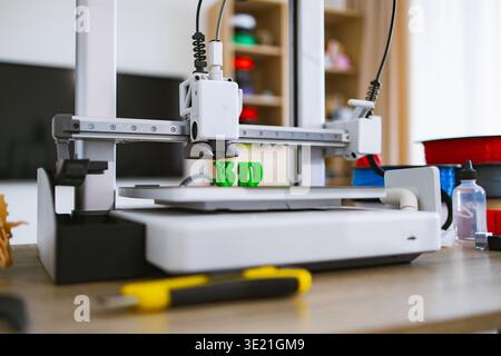 3D Printer Creating Green Letters Stock Photo