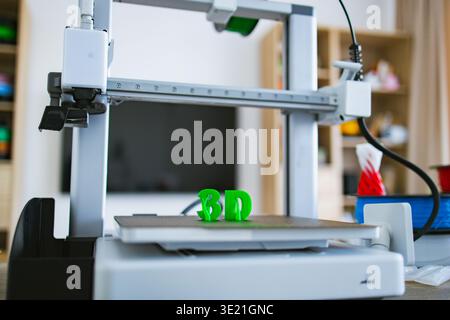 3D Printer Creating Green Letters Stock Photo