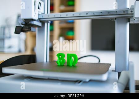 3D Printer Creating Green Letters Stock Photo