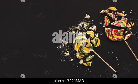 Crashed lollipop candies on black background Stock Photo