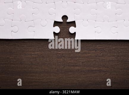 Collection of Puzzle Pieces Laid on a Wooden Table Showing an Incomplete Mosaic Design Stock Photo