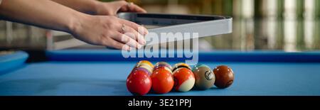 Header of Young Adult Woman Arranging Billiard Balls on Pool Table Indoors Stock Photo