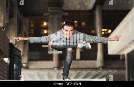 Handsome man practicing yoga in the city Stock Photo