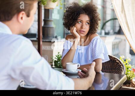 Black woman disinterested with blind date outdoors Stock Photo