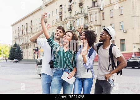 Multiracial friends tourists making selfie in city Stock Photo