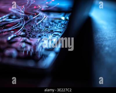 Fibre optics carrying data into a laptop computer Stock Photo