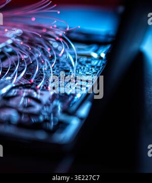 Fibre optics carrying data into a laptop computer Stock Photo