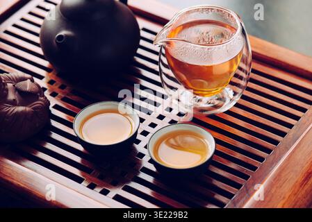 Teapot and cups with Chinese tea on the table Stock Photo