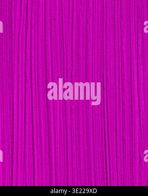 Abstract texture with vibrant magenta and vertical streaks creating a dynamic pattern. Stock Photo