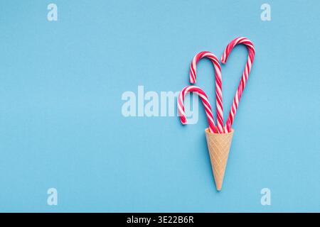 Candy canes on blue background - Christmas concept Stock Photo