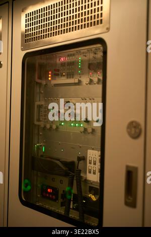 A close-up view of a control panel with various buttons and indicator lights inside a casing. Zurich, Switzerland Stock Photo