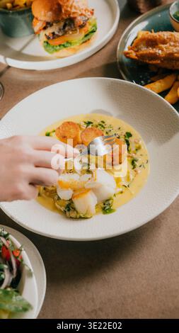 Delicious cod and cheese soup, creamy and warming, served in deep bowl ...