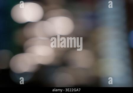 Blurred background with soft bokeh lights in various colors creating an abstract visual effect suitable for backgrounds or artistic designs Stock Photo
