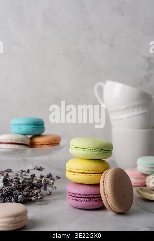 French dessert colorful macaroons on the table, decorated with flowers Stock Photo