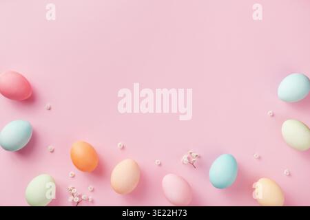 Pastel Easter eggs on pink background top view. Flat lay style. Stock Photo