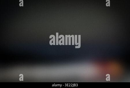 Abstract blurred background with soft gradients of dark colors and hints of light, creating a subtle and indistinct visual effect suitable for various Stock Photo