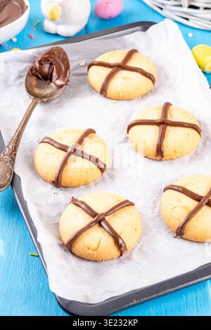 Hot cross bun crumble cookies with cross on it, made with chocolate paste topping, simple Easter holiday dessert idea Stock Photo
