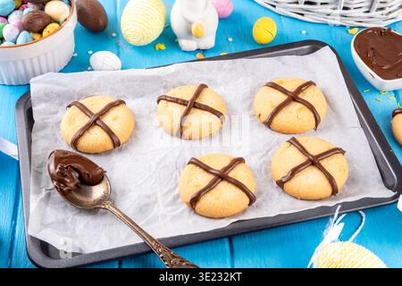 Hot cross bun crumble cookies with cross on it, made with chocolate paste topping, simple Easter holiday dessert idea Stock Photo