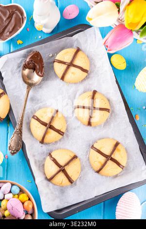 Hot cross bun crumble cookies with cross on it, made with chocolate paste topping, simple Easter holiday dessert idea Stock Photo
