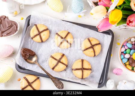 Hot cross bun crumble cookies with cross on it, made with chocolate paste topping, simple Easter holiday dessert idea Stock Photo