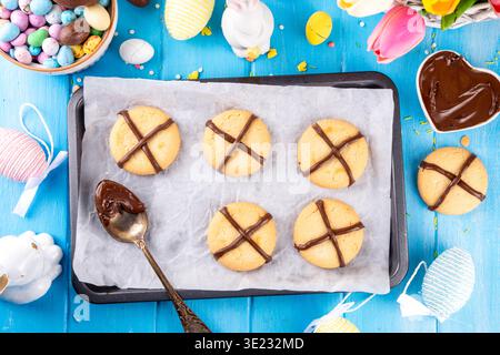 Hot cross bun crumble cookies with cross on it, made with chocolate paste topping, simple Easter holiday dessert idea Stock Photo